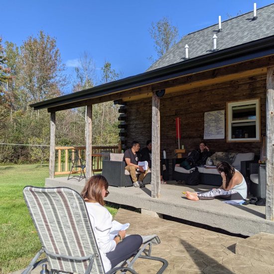 Cabin porch with people working