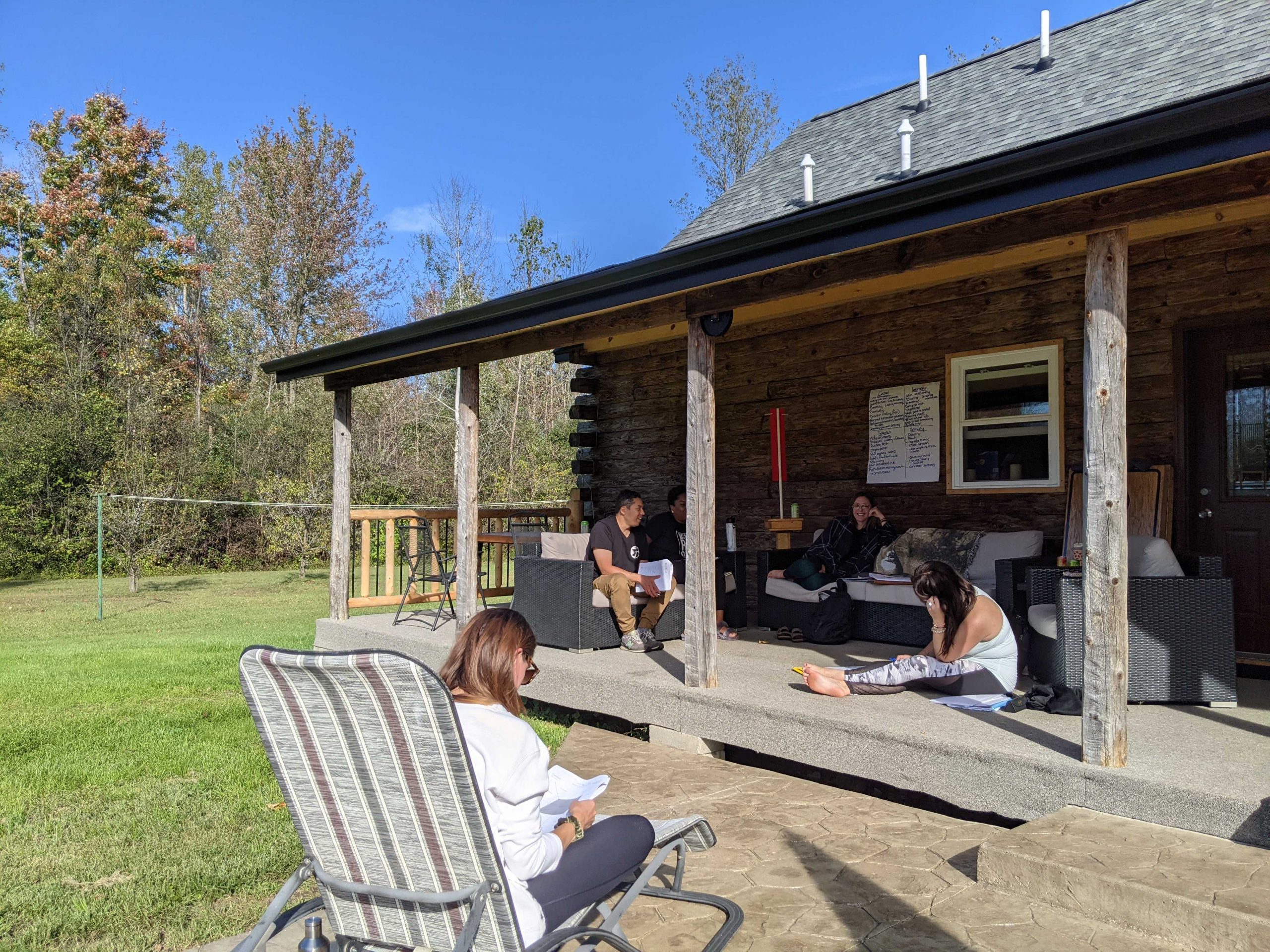 Cabin porch with people working